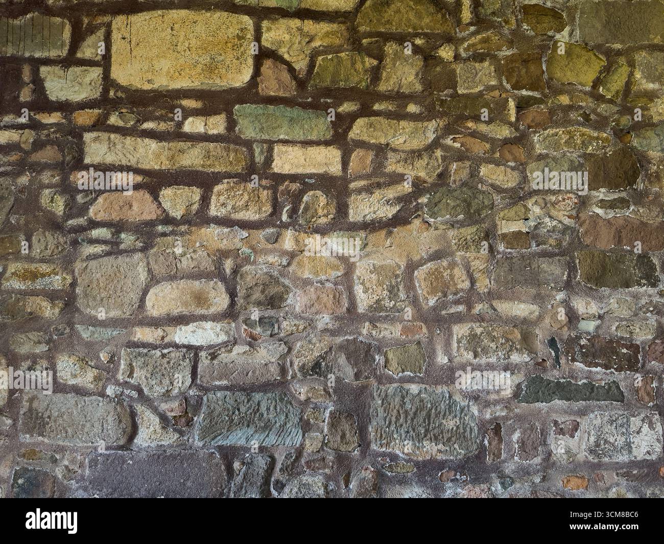 Rustic stone wall with multicolored natural rocks and mortar Stock ...