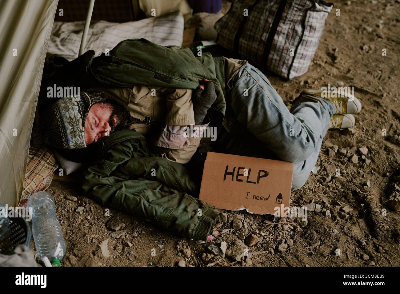 Homeless Caucasian Man Sleeping Outdoors Holding Cardboard Sign Asking Help Stock Photo