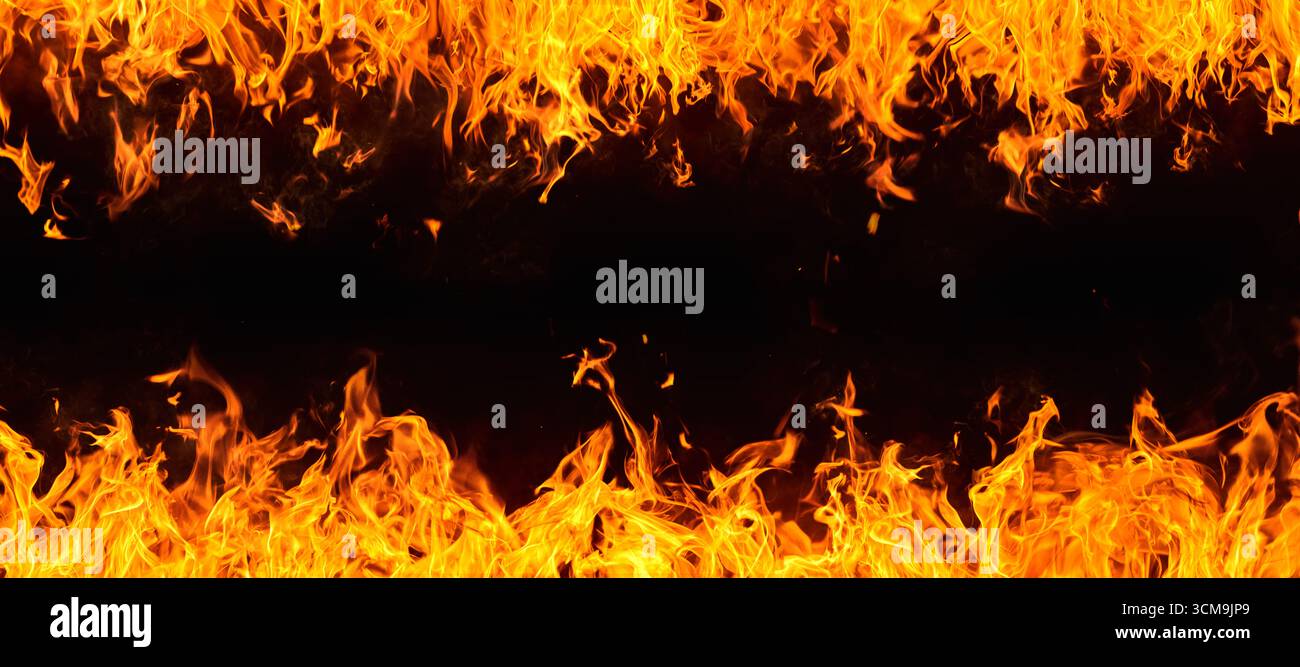 Frame of dramatic red, orange, yellow flames and smoke rising against a ...