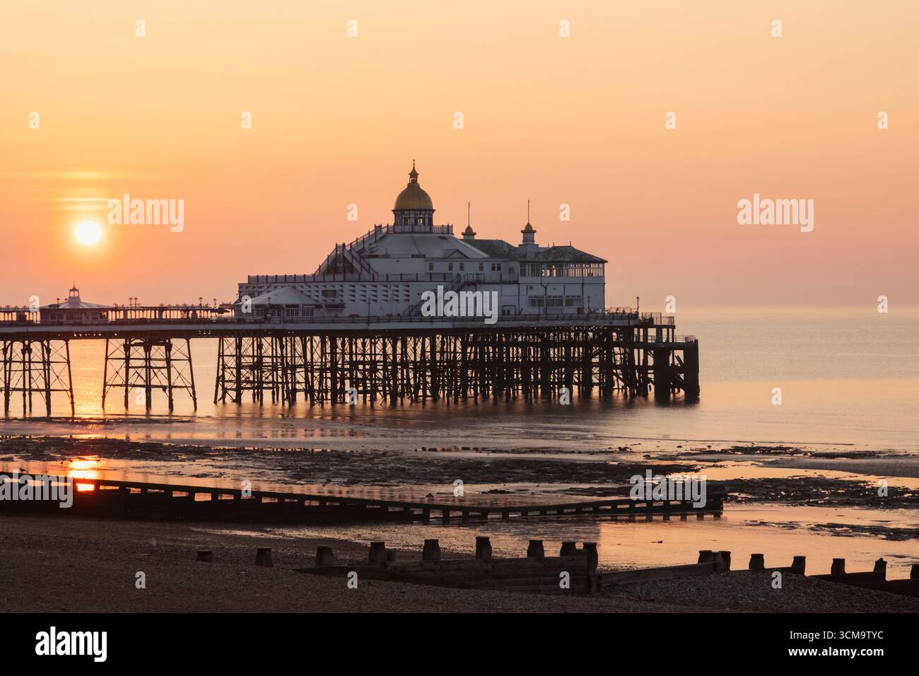 England, Sussex, East Sussex, Eastbourne, Eastbourne Pier and Beach at Sunrise Stock Photo