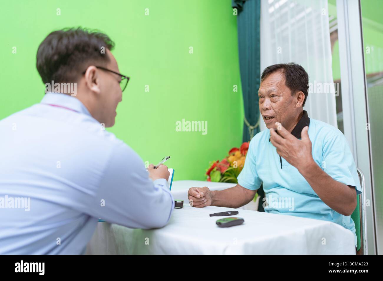 An Engaging Conversation Between Two Thoughtful Individuals at a Table Stock Photo