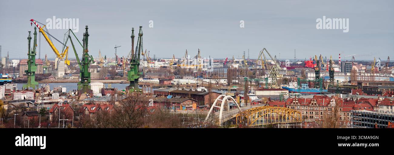 Panoramic view of shipyard with port cranes, industrial buildings and ...