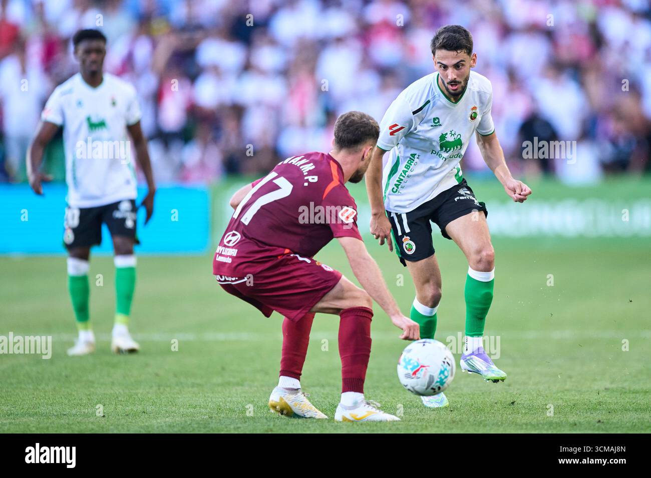 Andres Martin of Real Racing Club duels for the ball with Ivan Calero of Cultural y Deportiva Leonesa during the LaLiga Hypermotion match between Real Stock Photo