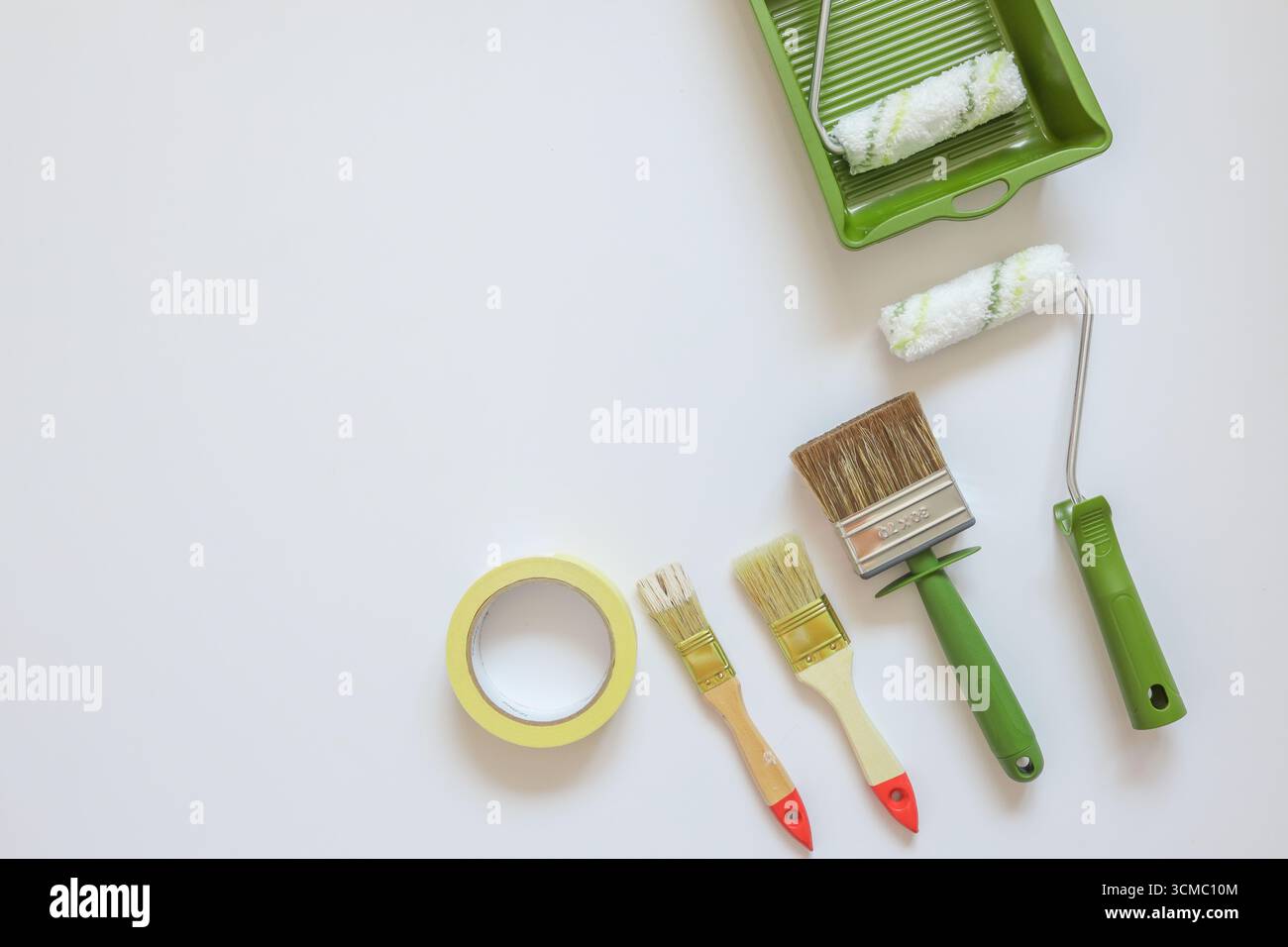 Top view wall painting tools on white background. Stock Photo