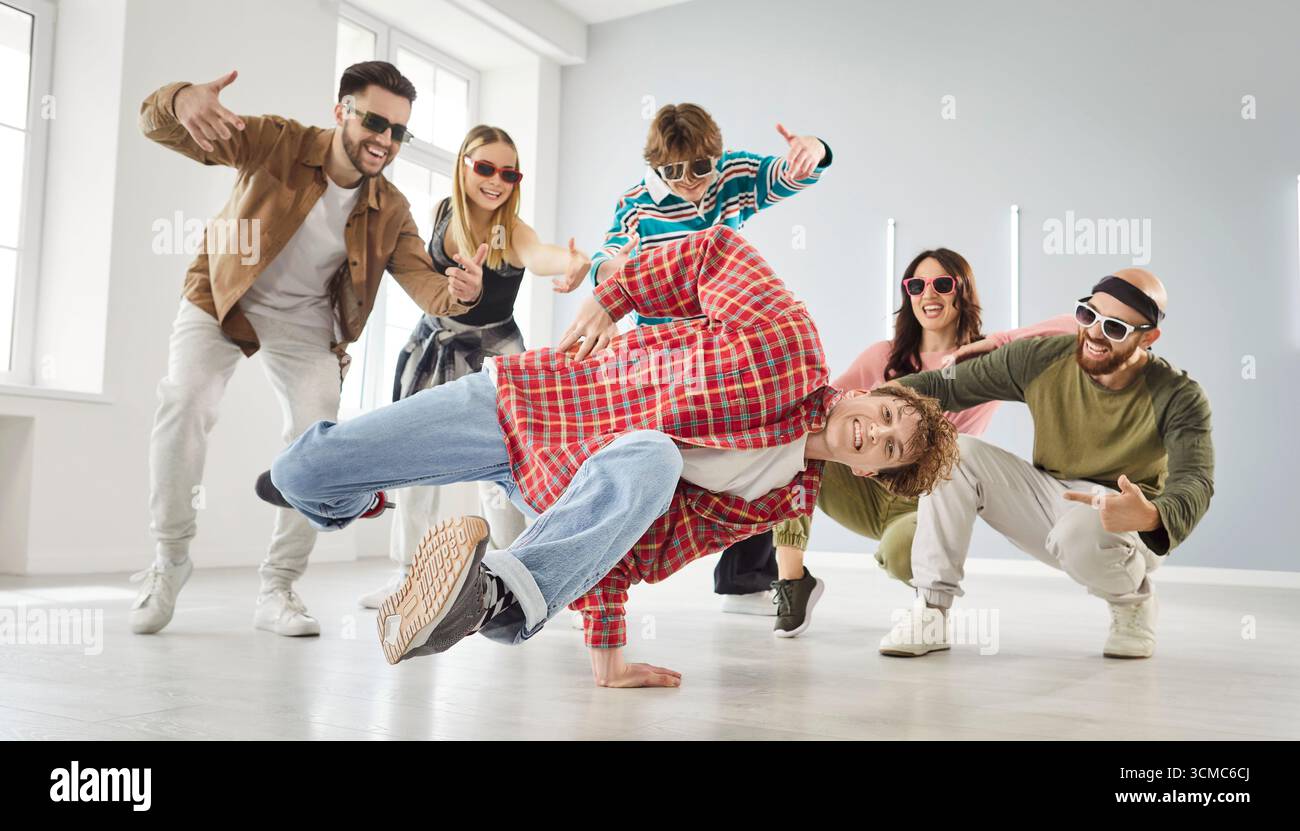 Group of happy young dancers enjoying break dance at a modern choreography studio Stock Photo