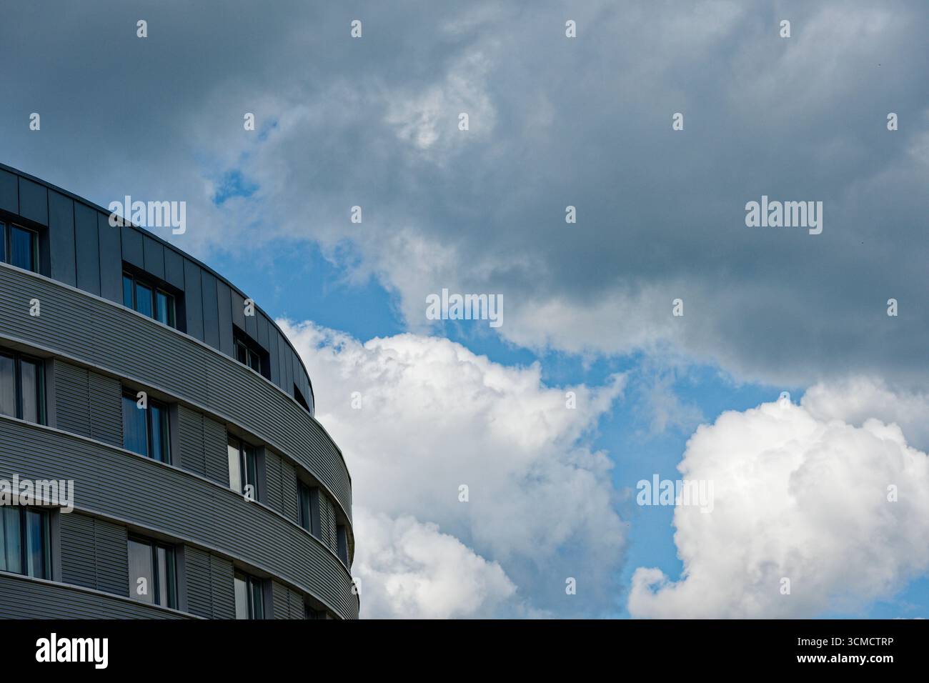 Gently Rounded Build A rounded street facade curves gently across three floors. Darker ...