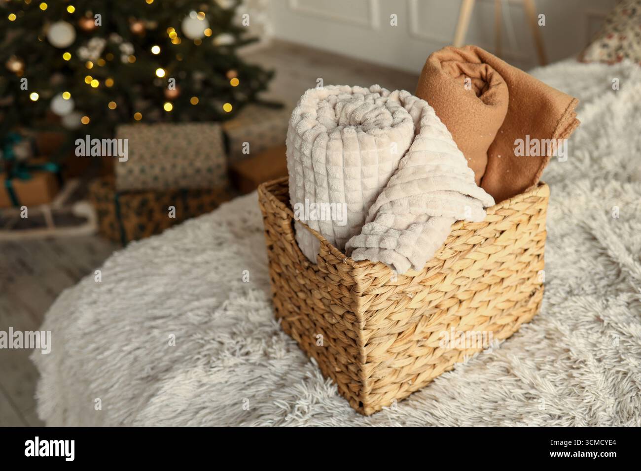 Wicker basket with cozy blankets, home mood. Stock Photo