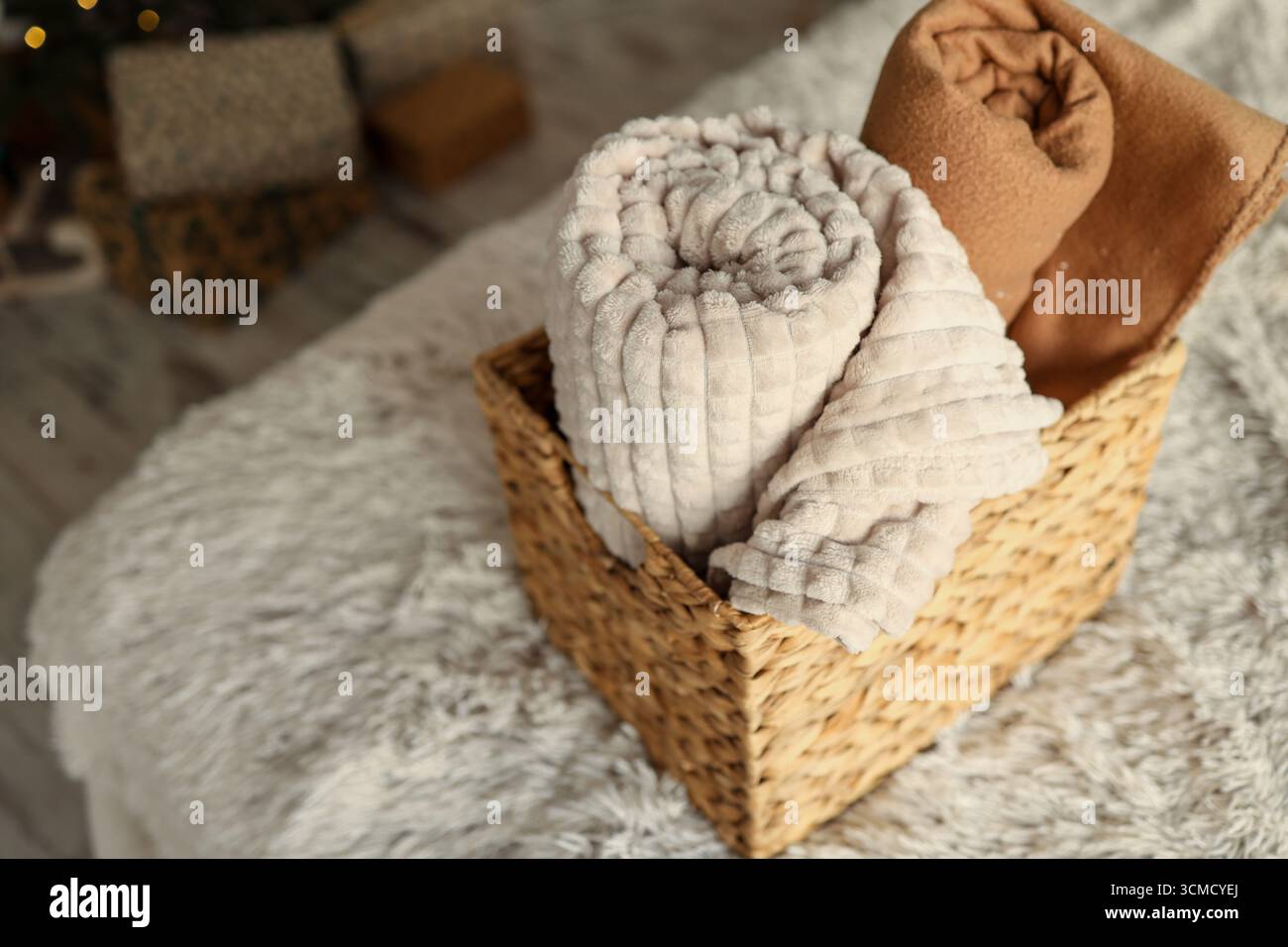 Wicker basket with cozy blankets, home mood. Stock Photo