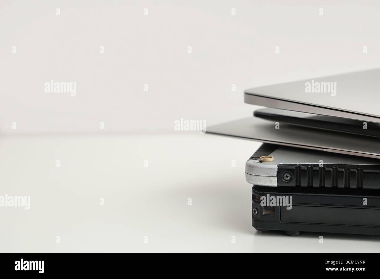 Stack of different modern gadgets on light background Stock Photo