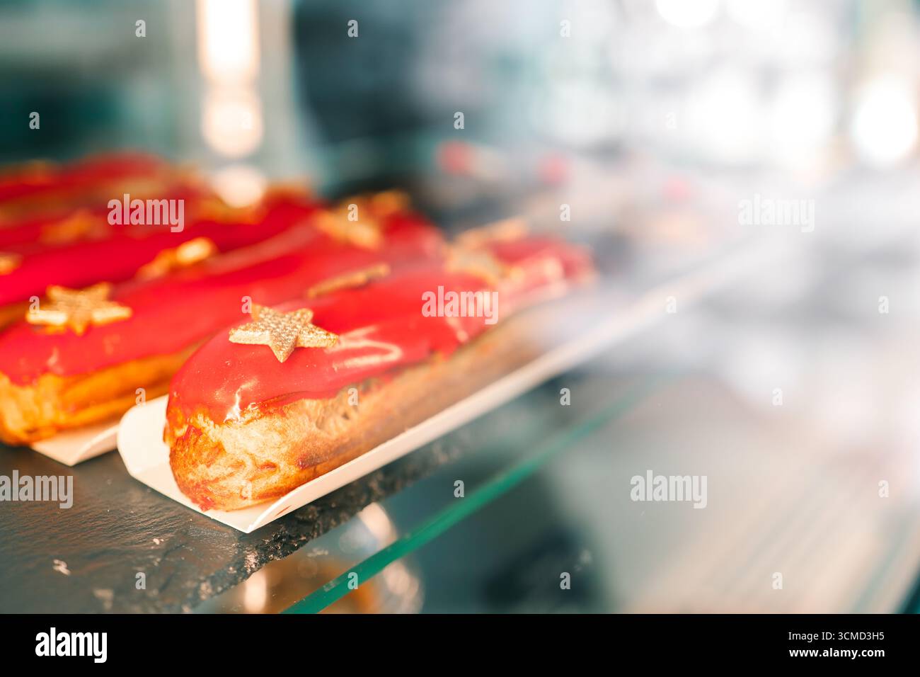 Freshly baked eclairs on display in a cafe. Stock Photo