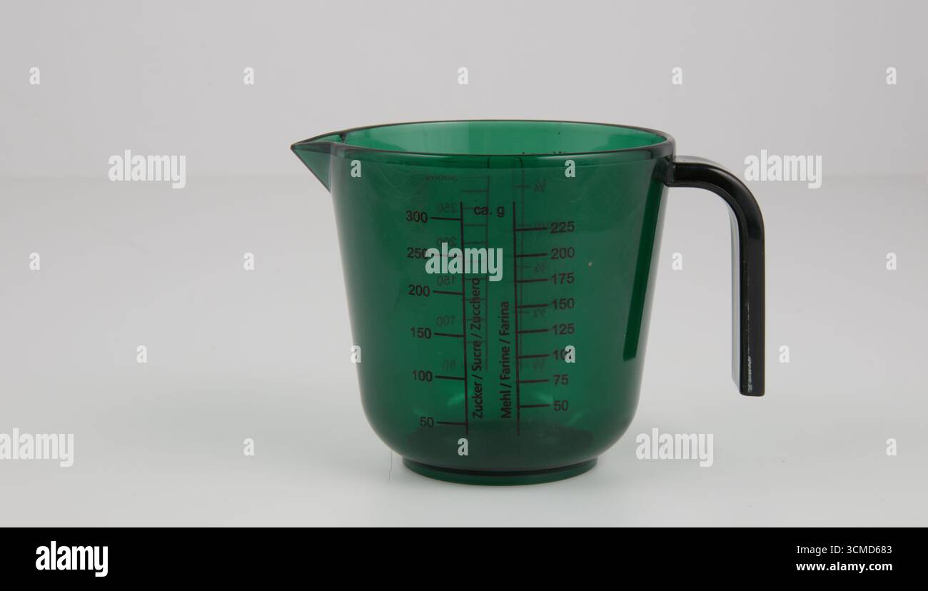 Green measuring cup isolated nature background with clipping path Stock Photo