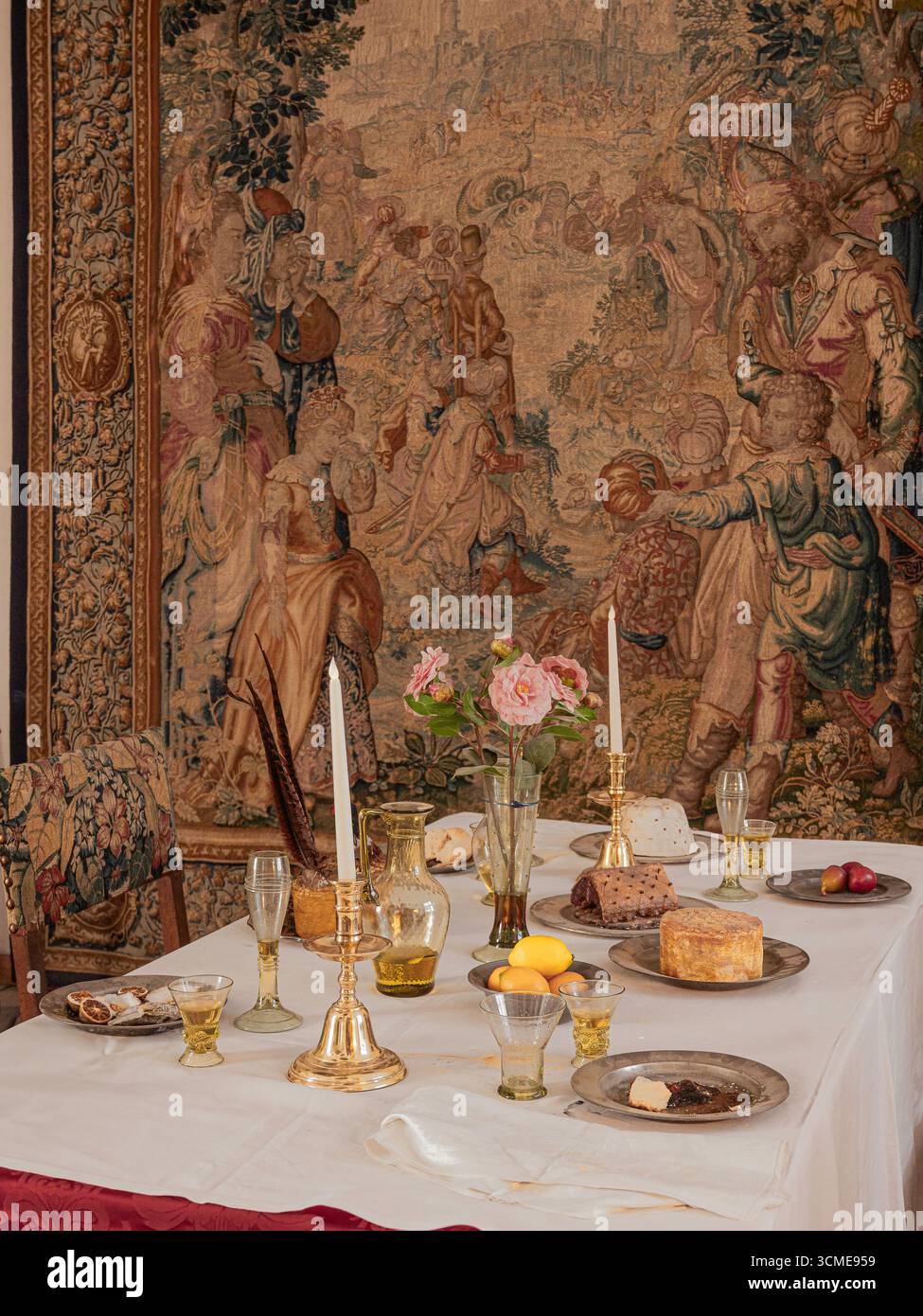 table setting from the 16th-century with historic details, and a tapestry in the background, Denmark, August, 2025 Stock Photo