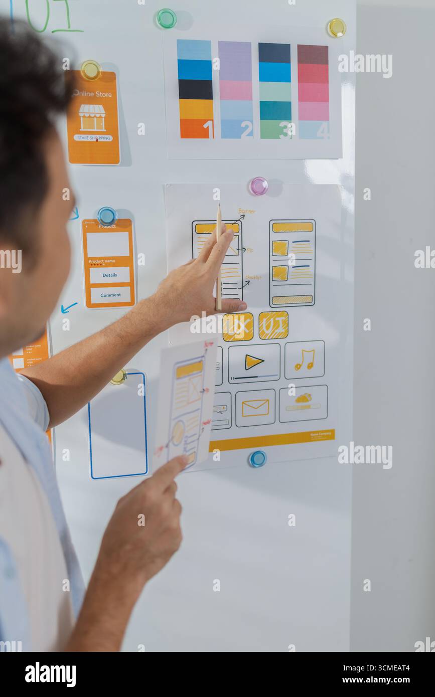 Pinned Table Ui A focused designer is working on UX/UI design ideas, analyzing color ...