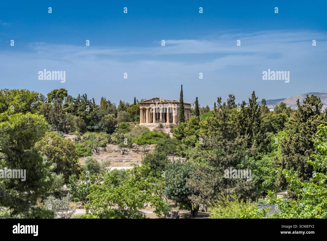 Temple of Hephaestus with foreground trees in the Ancient Agora of Athens, Greece. May 2025 Stock Photo