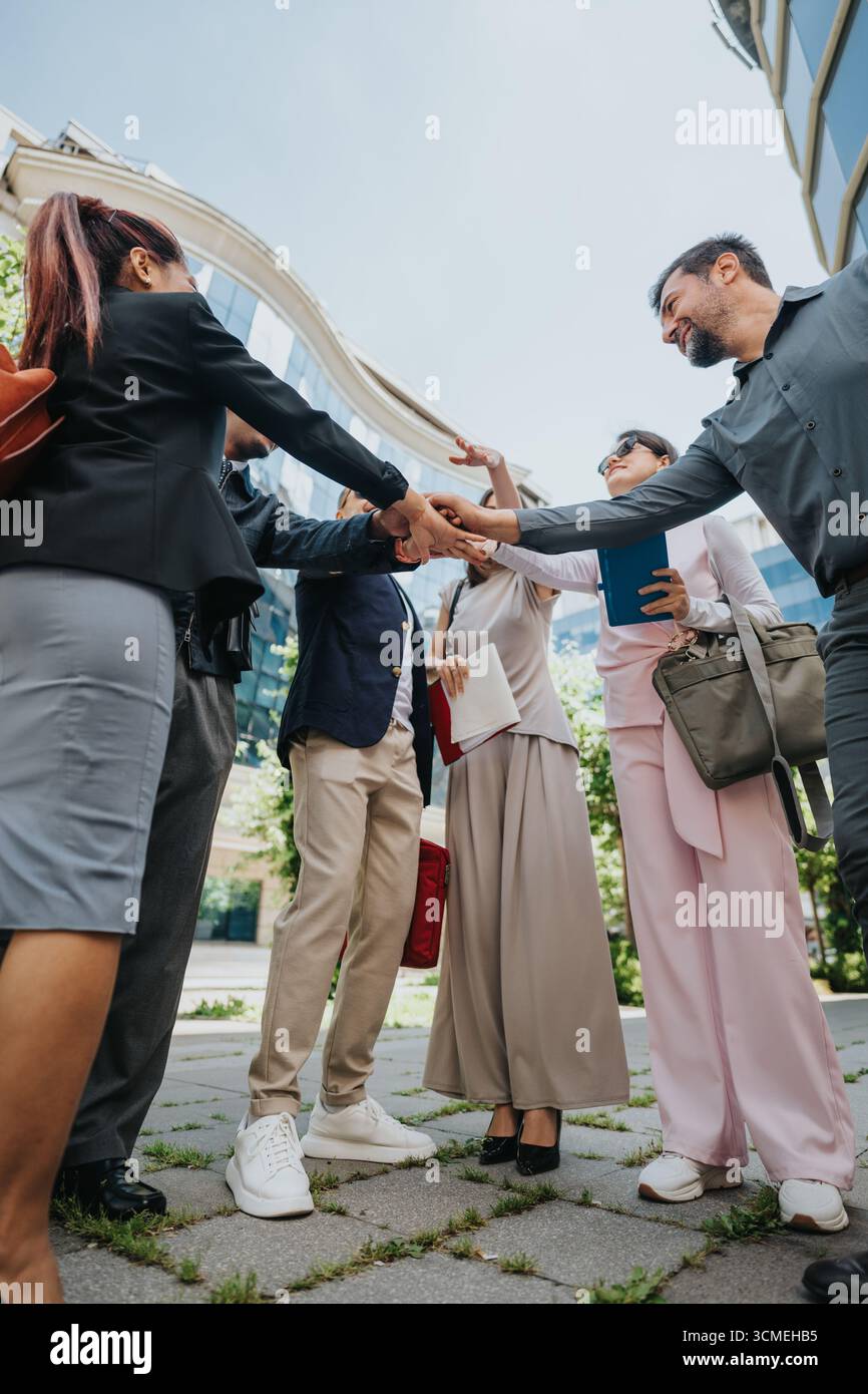 Multiracial colleagues collaborating outdoors in a dynamic team building activity Stock Photo