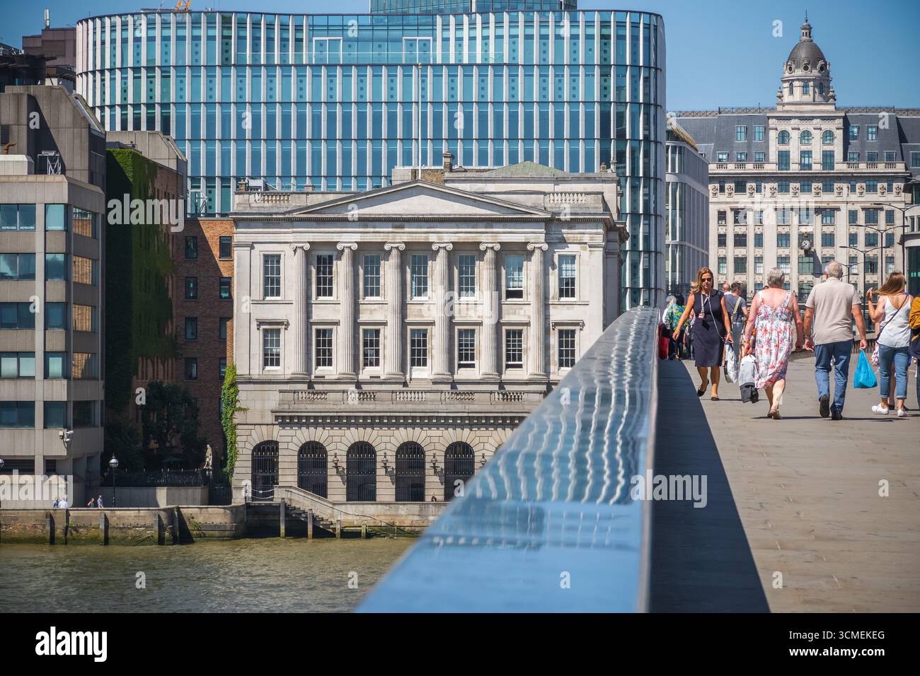 London, UK - 27 June, 2025 - Tourists on London Bridge with Fishmongers' Hall and King William Street in the background Stock Photo