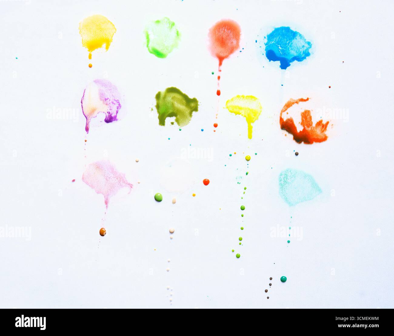splashes of color drips on white background Stock Photo