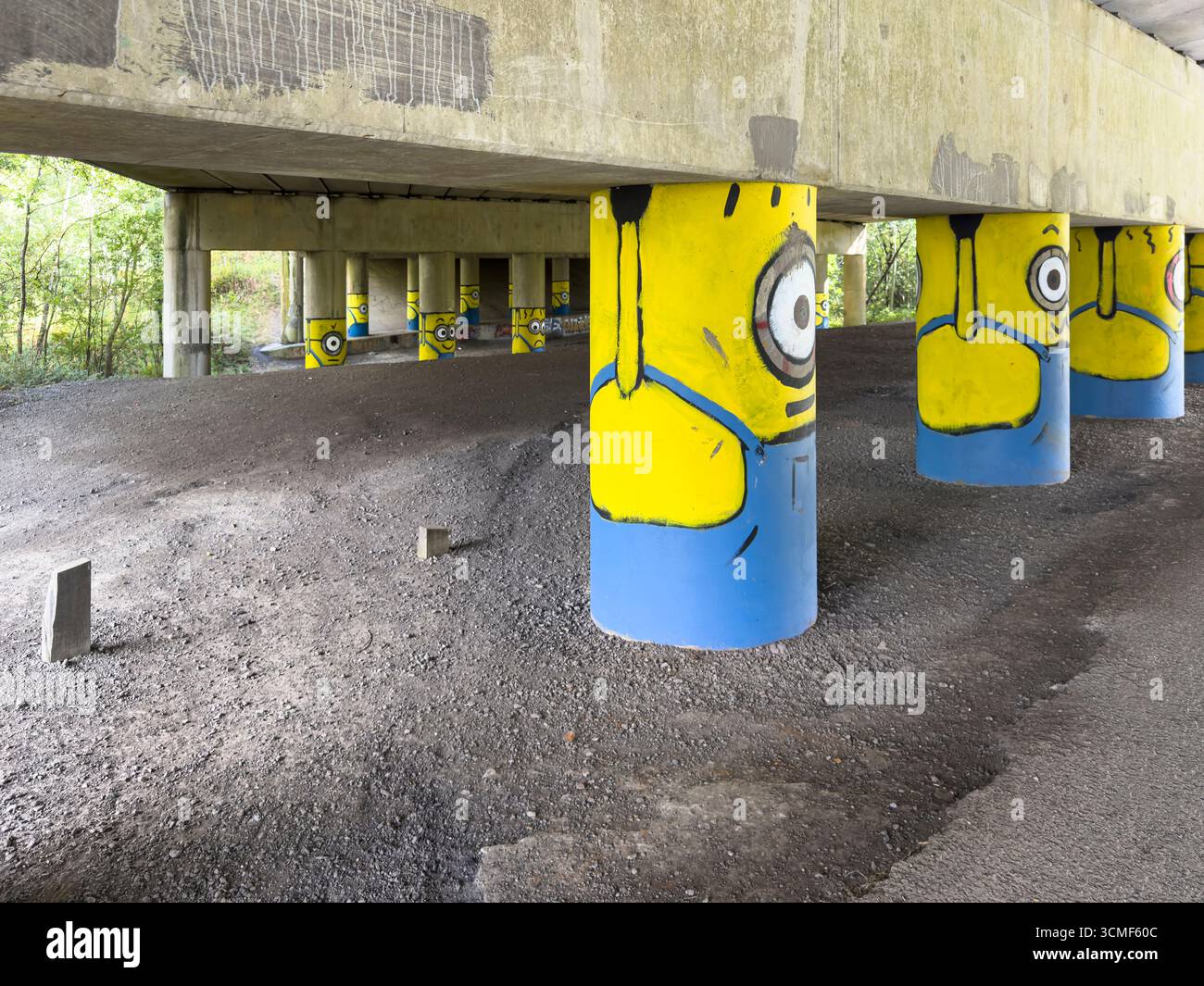 'Burnley Banksy' Minions on the motorway stanchions under the M65 near Hapton, Burnely, Lancashire - Smartphone Captured Stock Image
