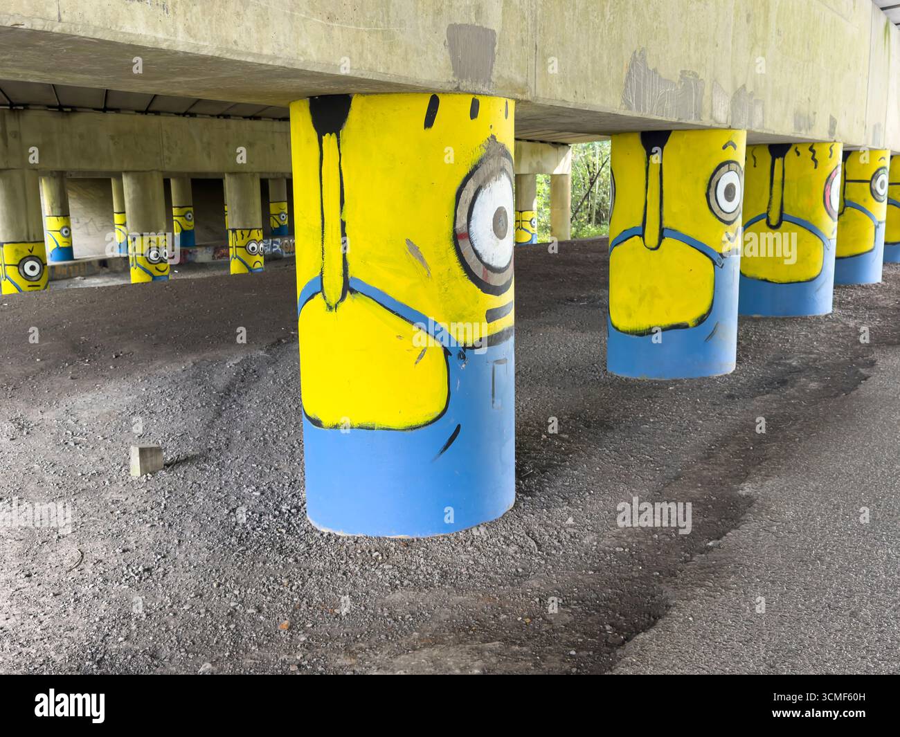 'Burnley Banksy' Minions on the motorway stanchions under the M65 near Hapton, Burnely, Lancashire - Smartphone Captured Stock Image