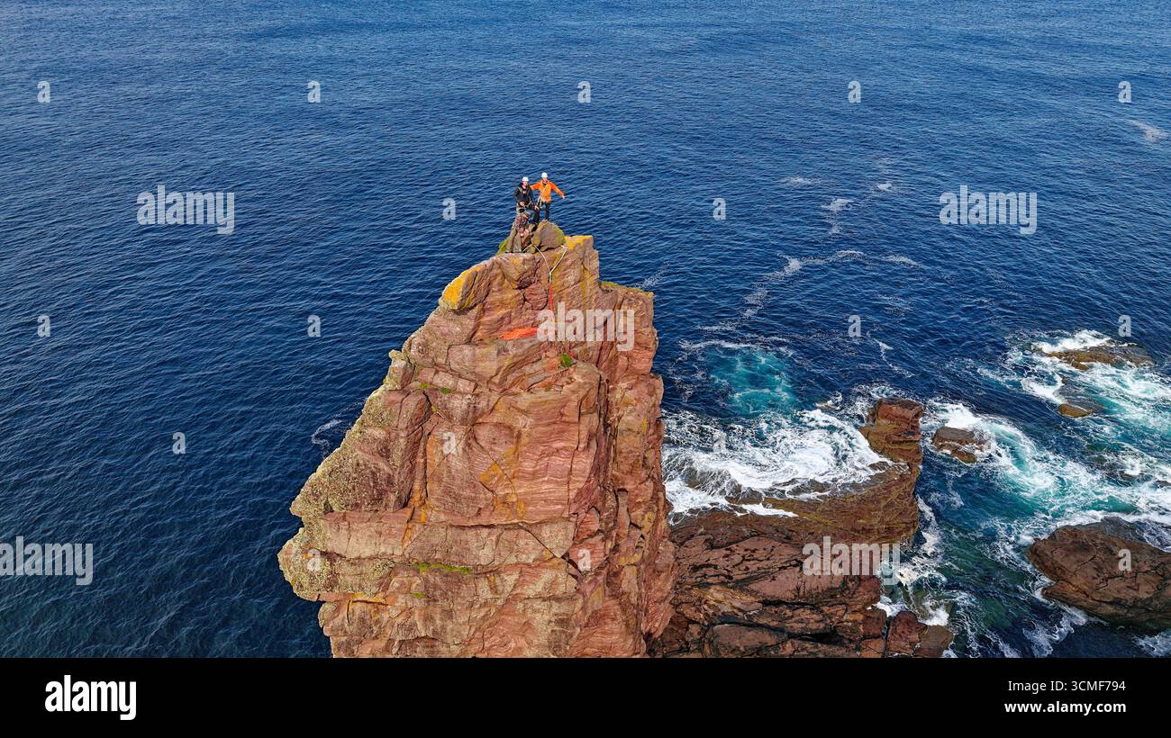 Old Man of Stoer Sutherland Scotland 200 ft sandstone sea stack three skilful climbers at the top Stock Photo