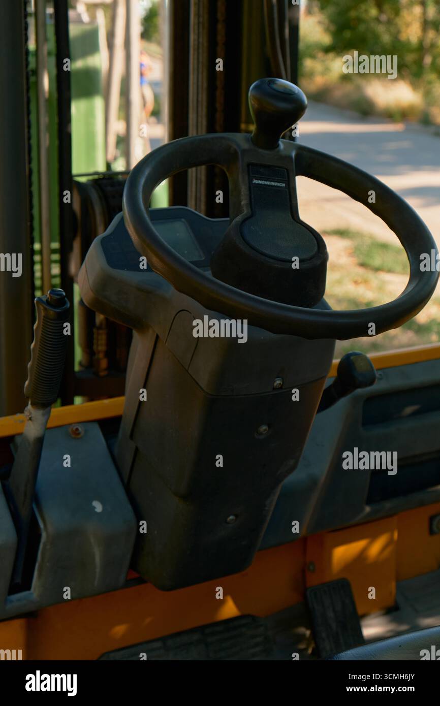 Front Loader Buttons Vertical photo of loader controls including steering wheel, gear lever ...