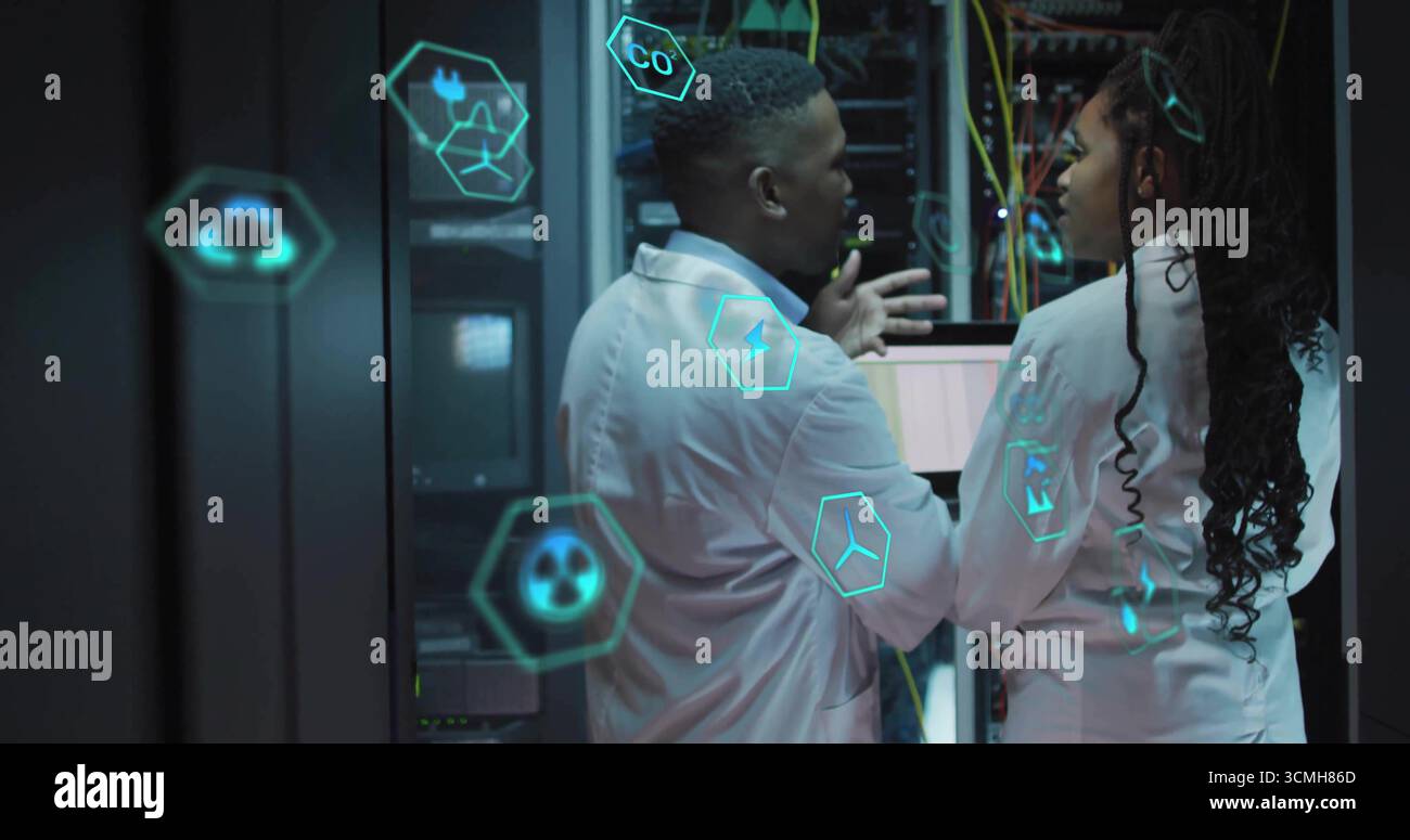 Engineers wearing lab coats analyzing server racks in datacenter, with ...