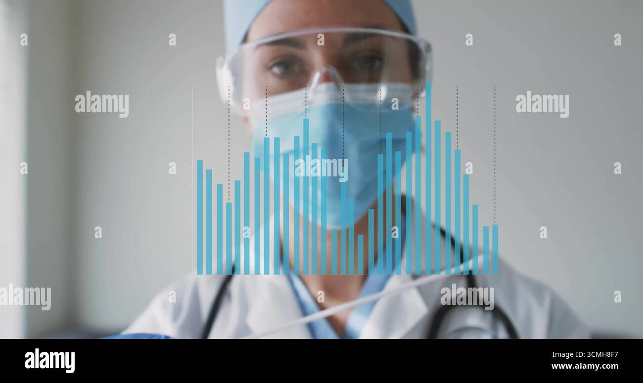 Displaying physician wearing labcoat and mask with stethoscope viewing digital bar chart in clinic Stock Photo