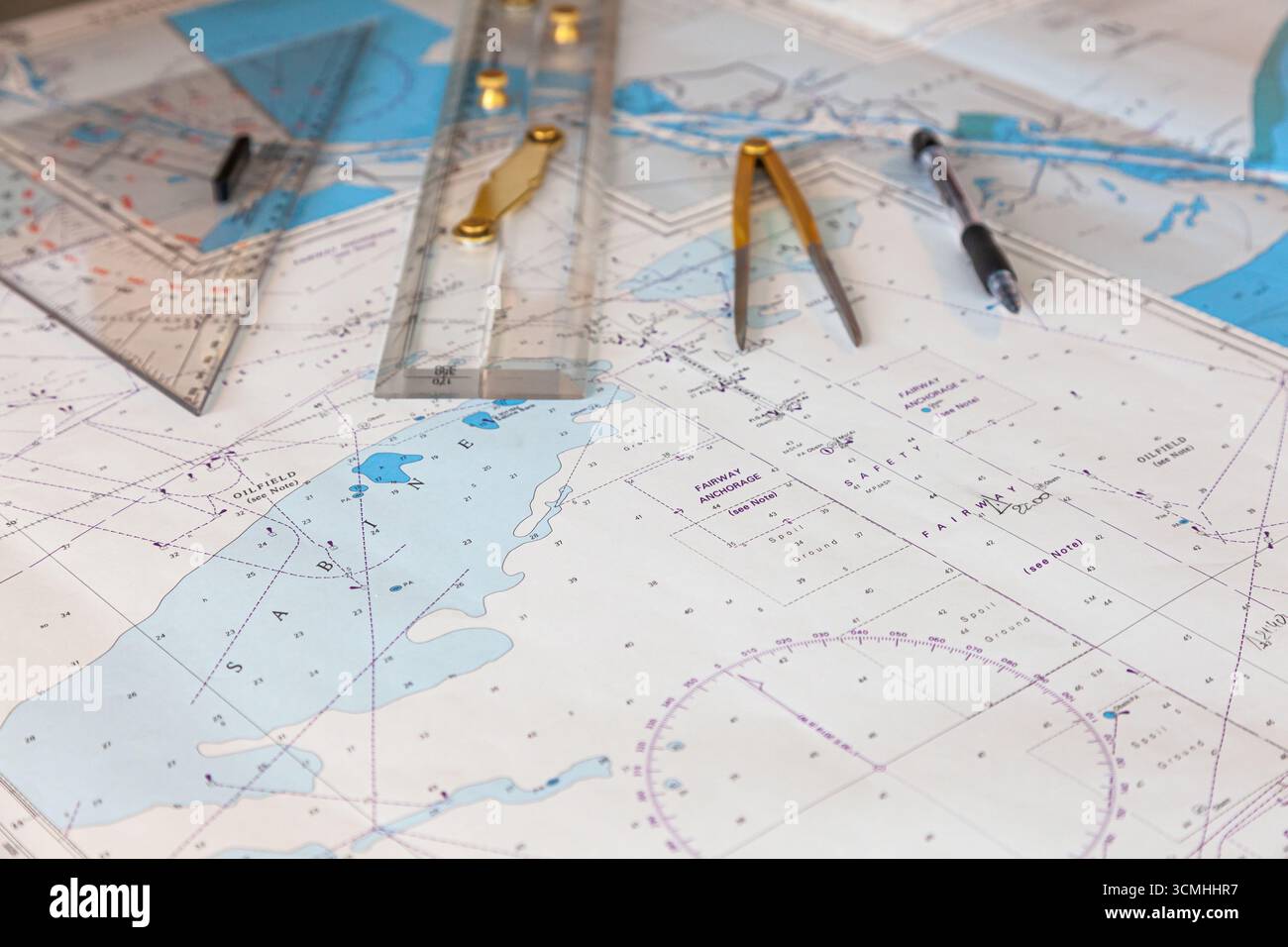 Navigation ship chart for building a sailing route. Plotter, divider, ruler and pen on a map. Stock Photo