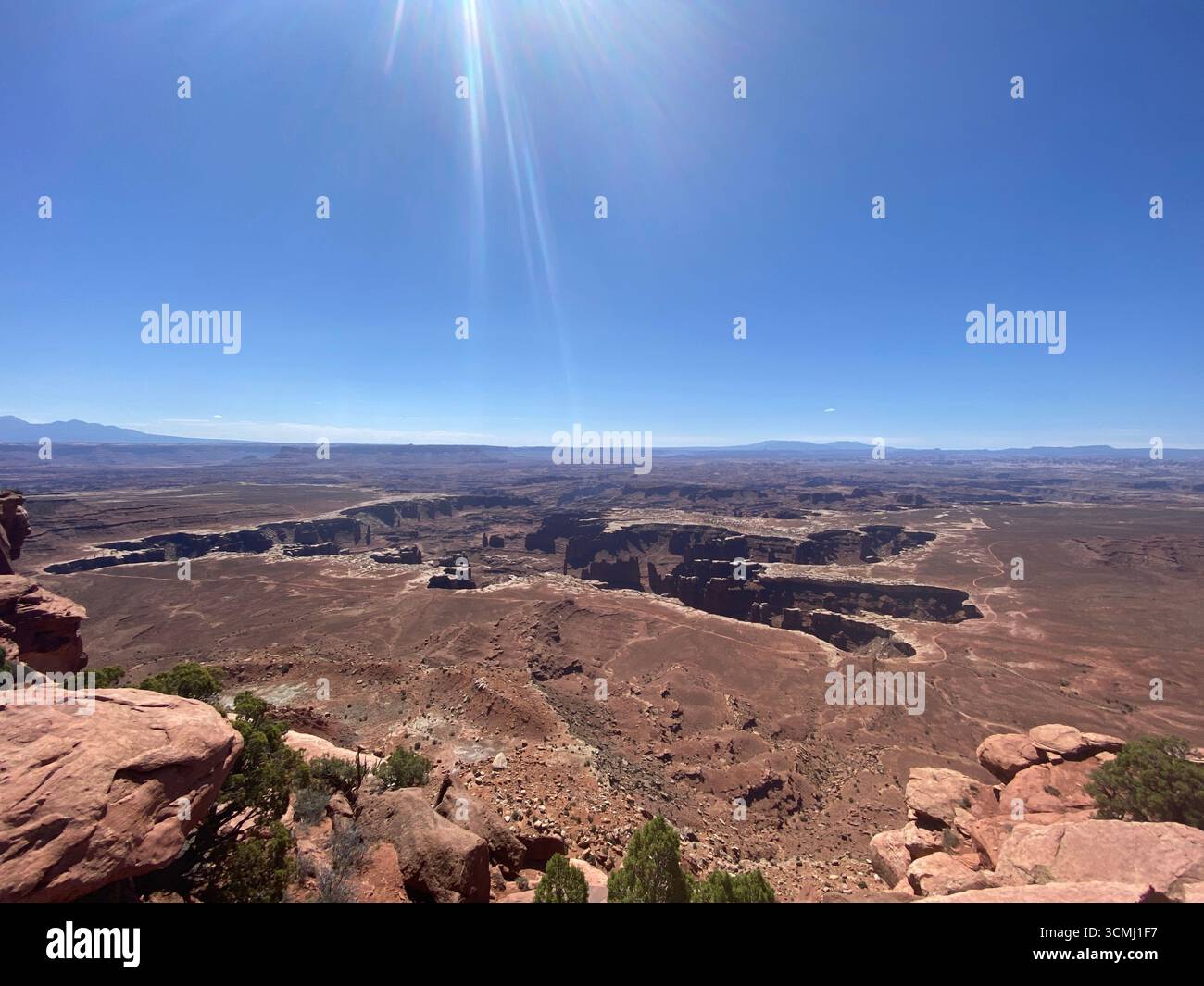 A sweeping landscape view from Grand View Point Overlook, looking down into the canyon, at the vast high desert in Canyonlands National Park, Utah, US - Smartphone Captured Stock Image
