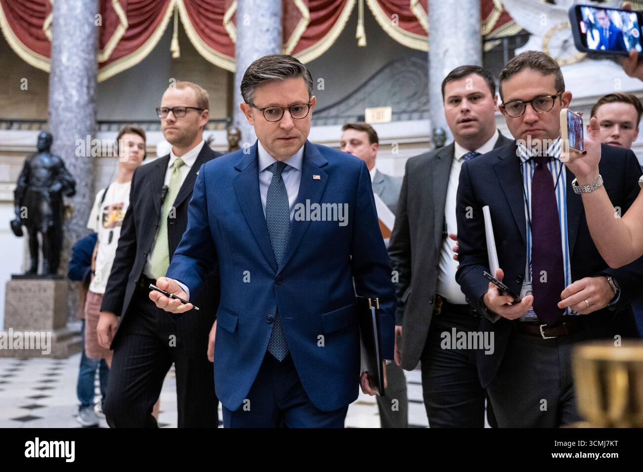 House Speaker Mike Johnson (R-La.) speaks with reporters as he walks to ...