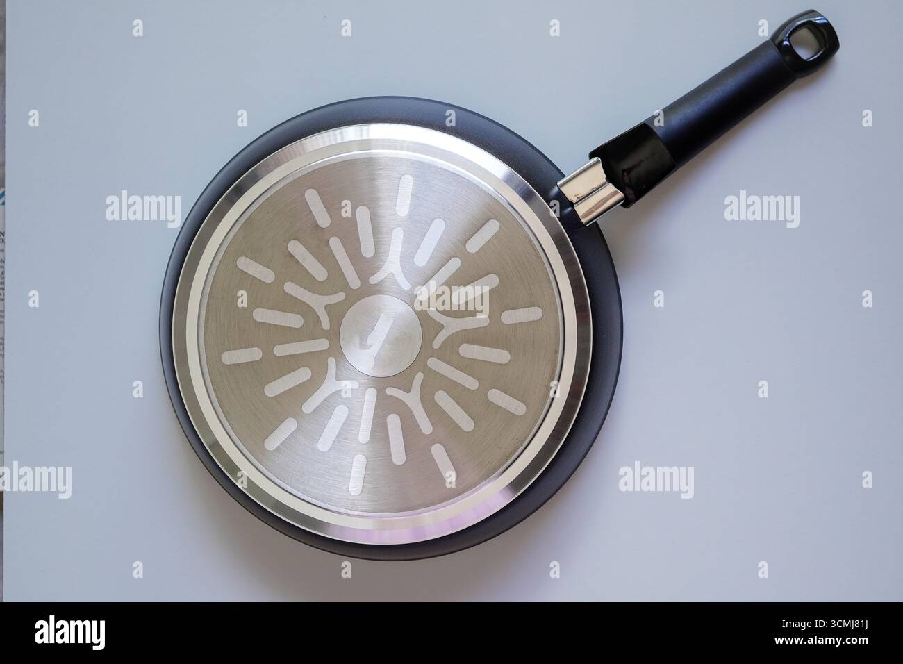 The bottom of the frying pan on white background Stock Photo
