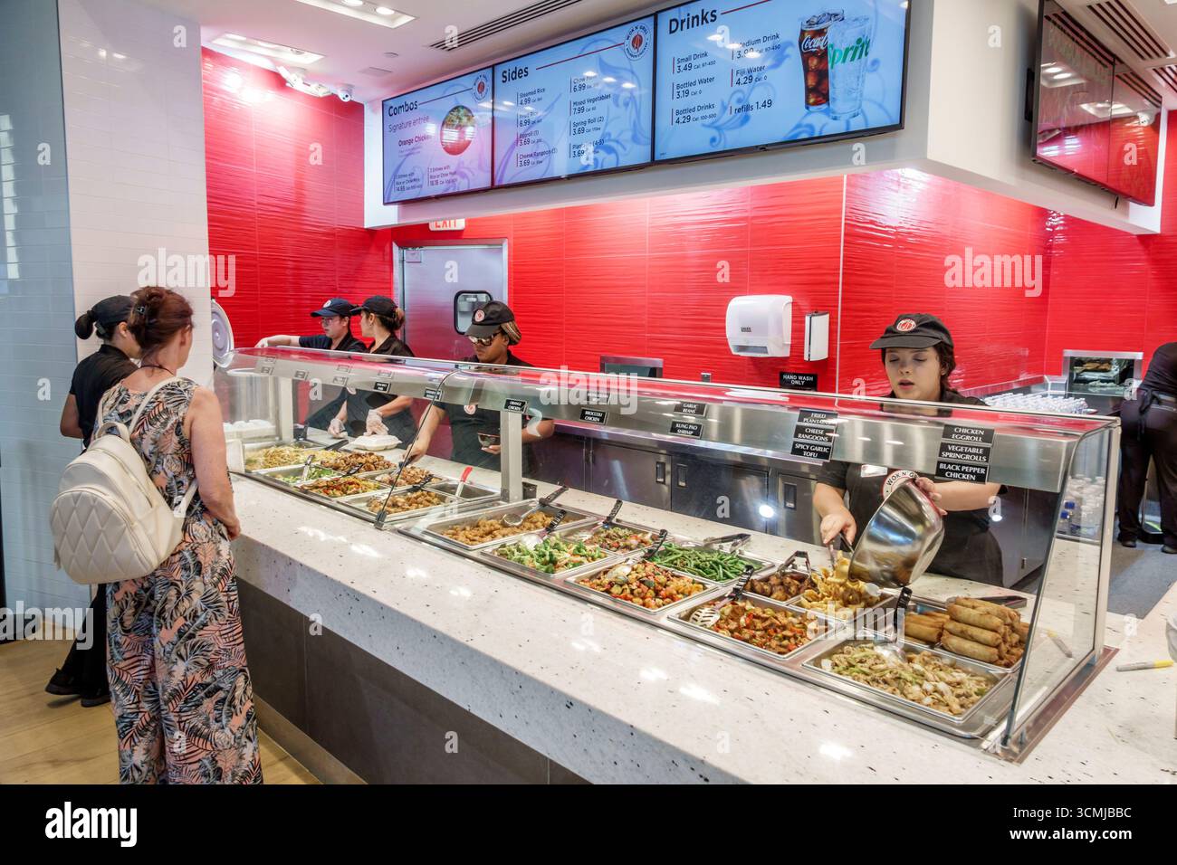 Aventura Mall Miami Florida,inside interior,food court,casual dining eating out,Panda Express Chinese restaurant,menu display combo plates,orange chic Stock Photo