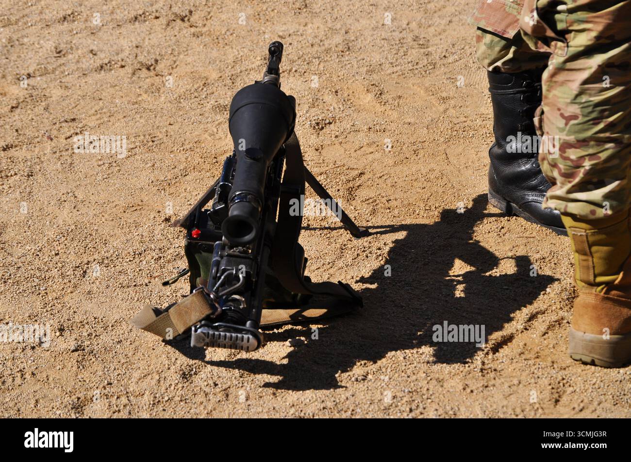 Rifle with telescopic sight on the ground next to soldiers, Military Parade in O'Higgins Park, Chile Stock Photo