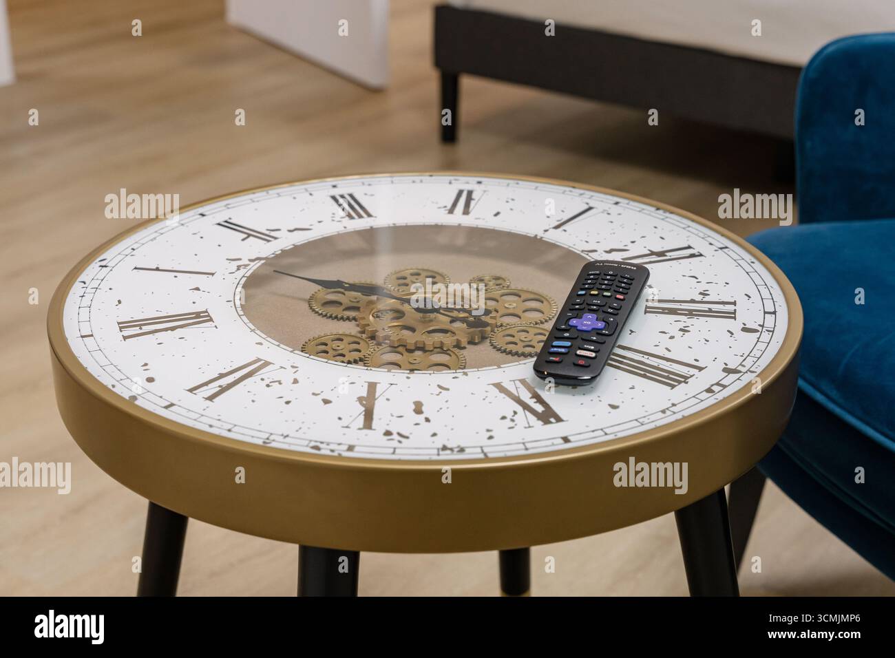 Unique clock table with visible gears and remote control in modern ...