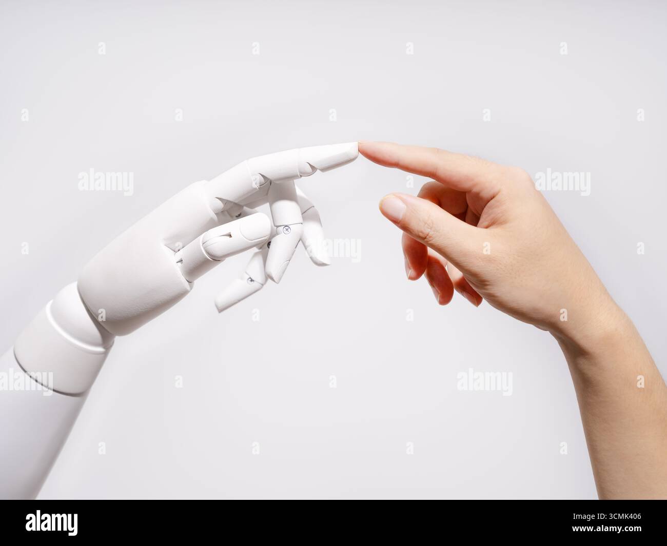 Human and robot fingertips touching Stock Photo