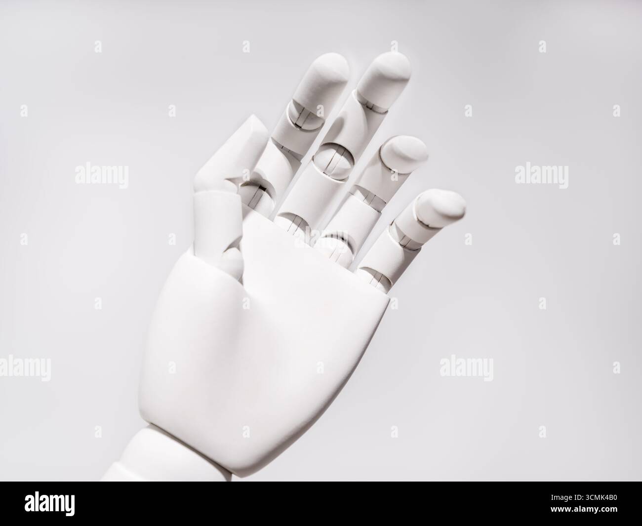 The robot's hand is on a white background Stock Photo