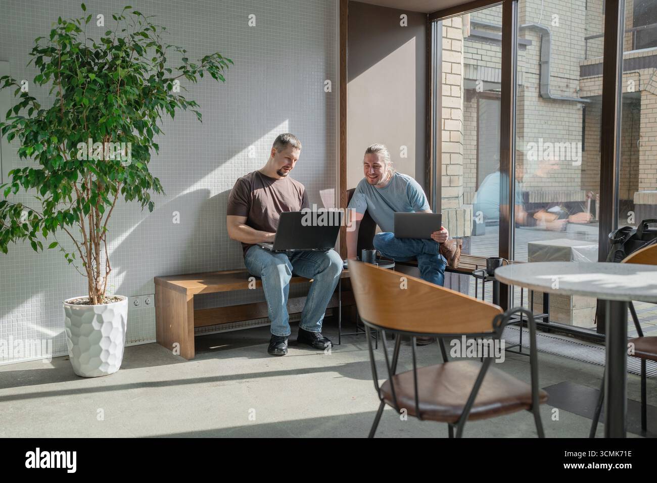 Two knowledgeable professionals collaborating effectively together in a modern workspace setting Stock Photo