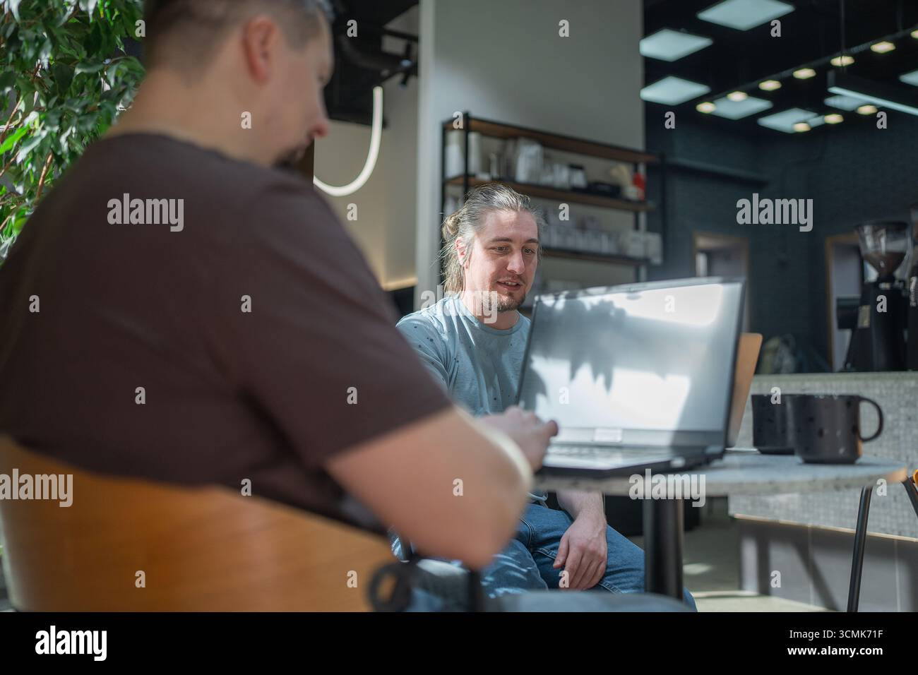 Two knowledgeable professionals collaborating effectively together in a modern workspace setting Stock Photo