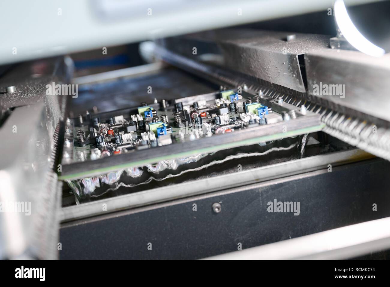 Wave soldering process for PCB tinning in molten solder bath under ...