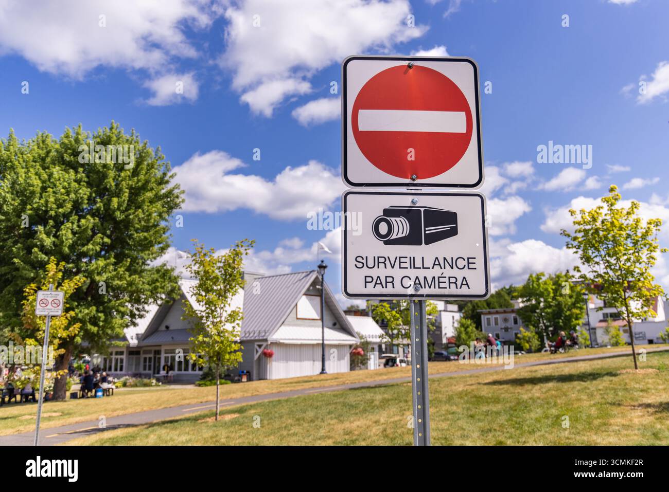 Do not enter and video surveillance sign indicating restricted area monitored by camera for security purposes in a public park Stock Photo