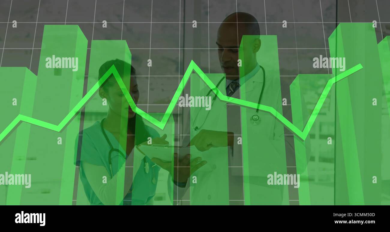 Reviewing doctor and nurse studying data in clinic corridor, with ...