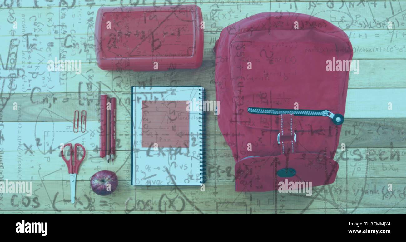 Displaying red backpack with apple and school supplies on wooden desk with math overlay, copy space Stock Photo