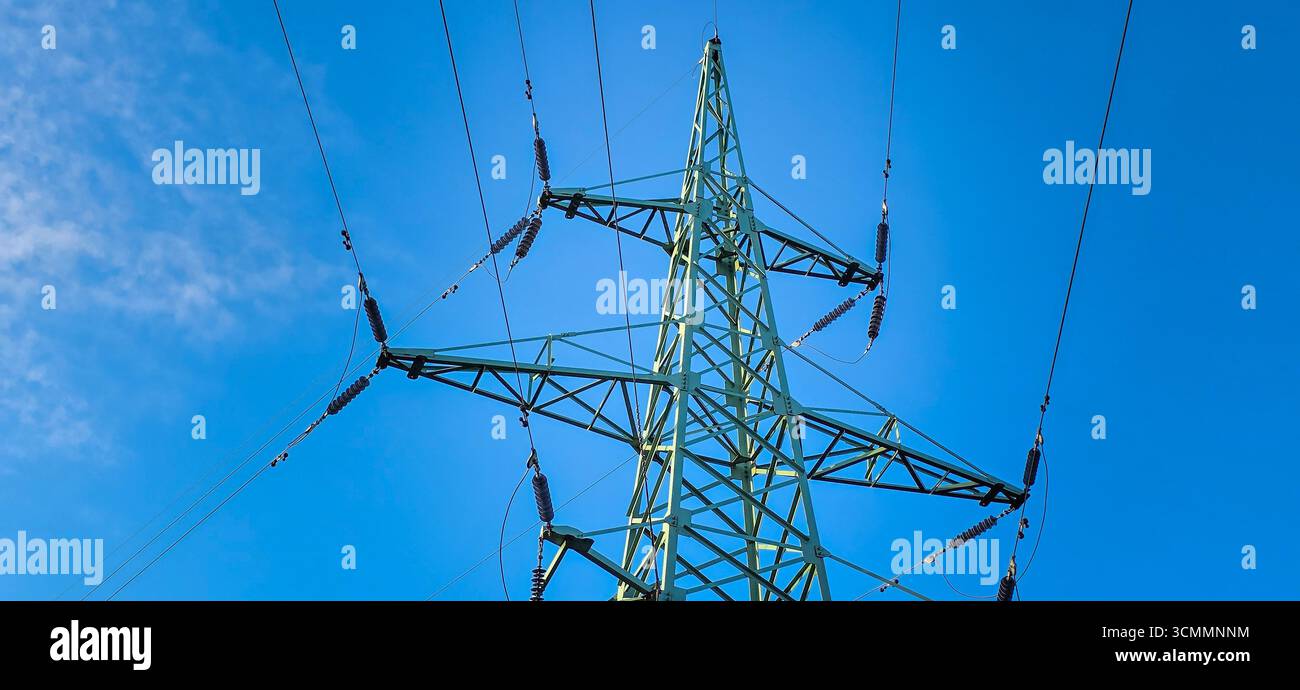 High voltage tower with power lines. Metal wires on a high-voltage ...