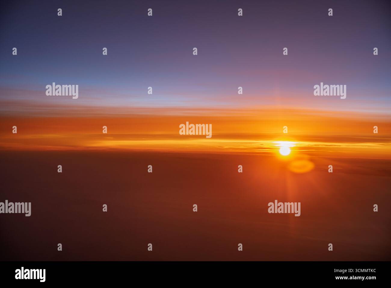 Bright colors fill the sky as the sun rises above a sea of clouds in ...