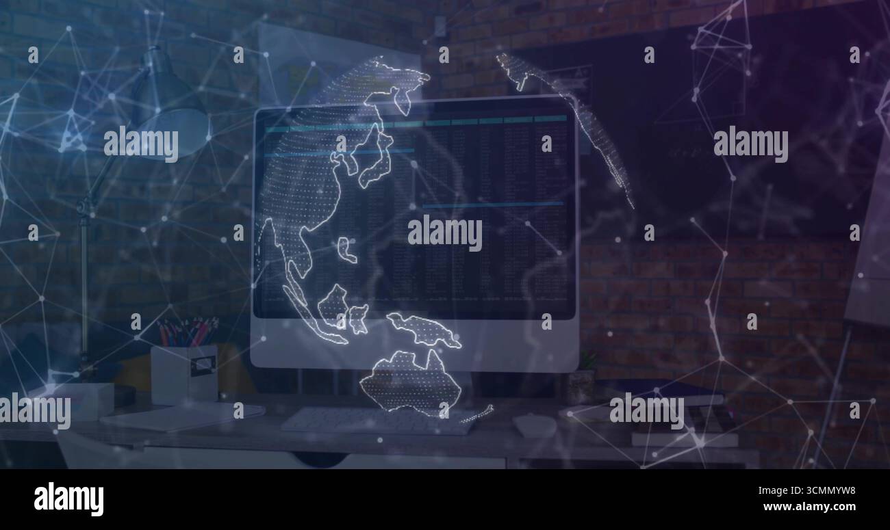 Displaying large monitor projecting network globe in tech workspace, with keyboard and lamp Stock Photo