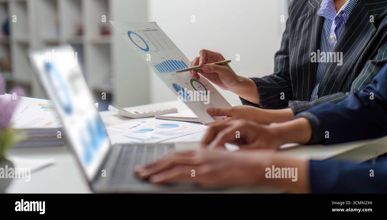 Data Visualization. Business team analyzing financial reports with charts and graphs. Stock Photo