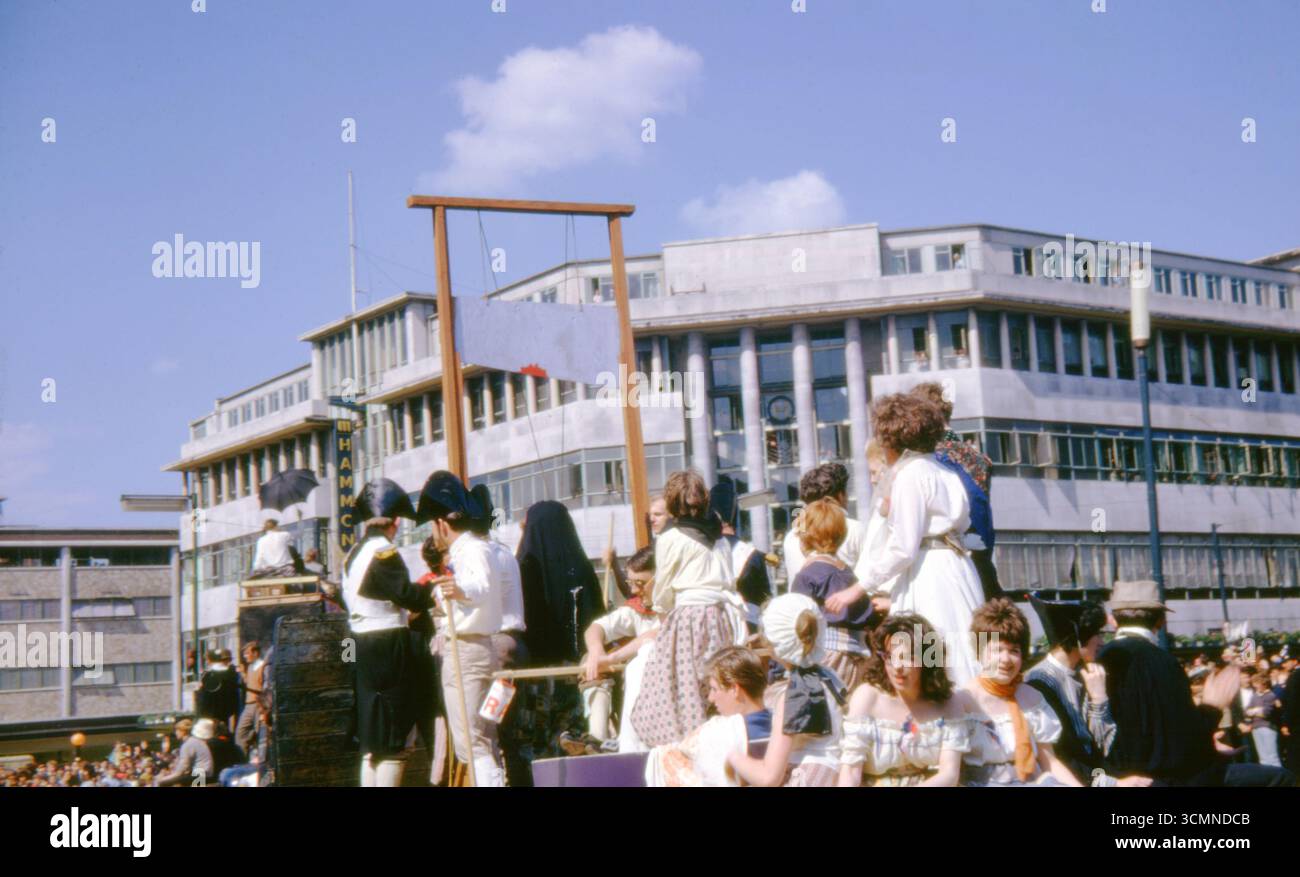 Students in costume ride a guillotine-themed float during Hull ...