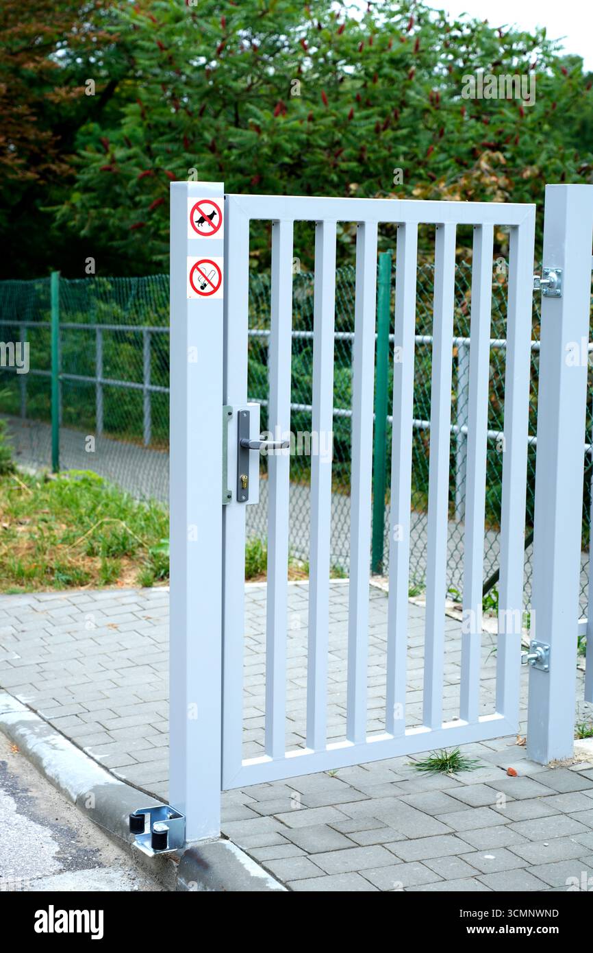 Metal gate with warning signs in the park Stock Photo - Alamy