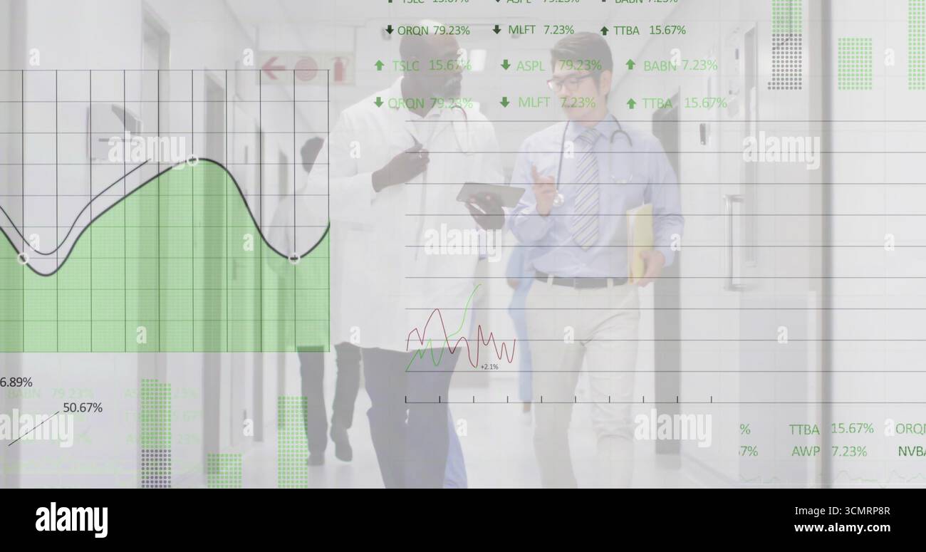 Walking medical team discussing data in hospital corridor, with tablet ...