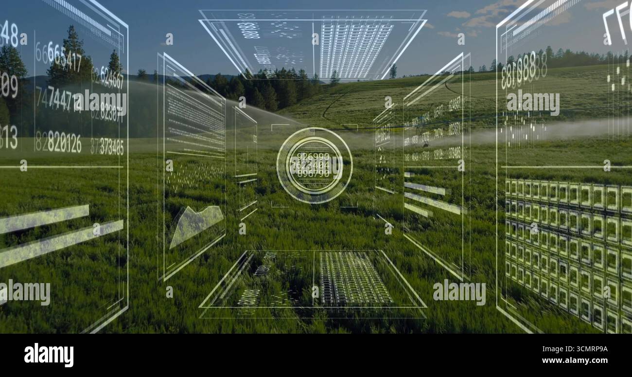 Floating circular digital interface hovering over rural hillside meadow, with numeric data panels Stock Photo